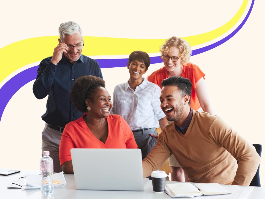 An image of give people huddled around a computer working at one of the best content writing agencies.