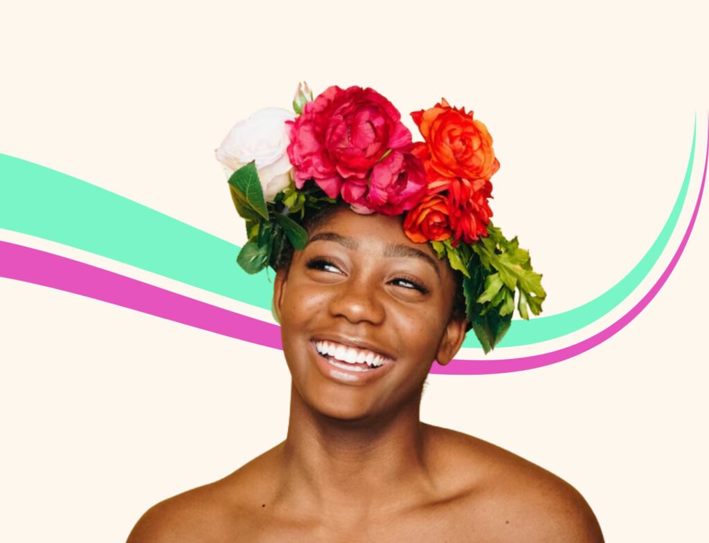 A woman wears a flower crown and smiles in front of a colorful backdrop and is featured in Lyon Content's article about tips for blogging for beauty brands.