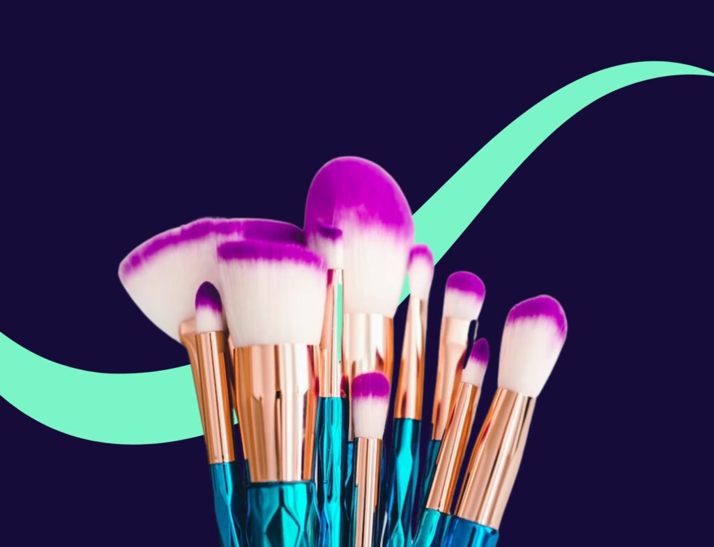 imagery of makeup brushes with a teal swirl behind and a navy background featured in a blog post about content writing for beauty brands.