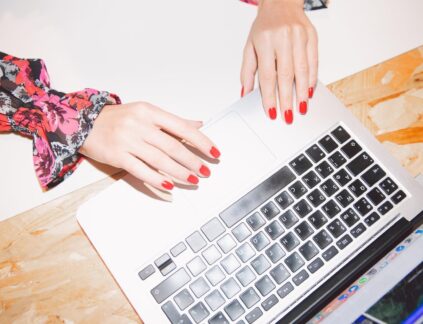 overview of woman beauty blog writing on laptop