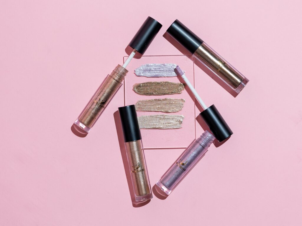 lip gloss tubes and swatches in an article about beauty industry trends and tips