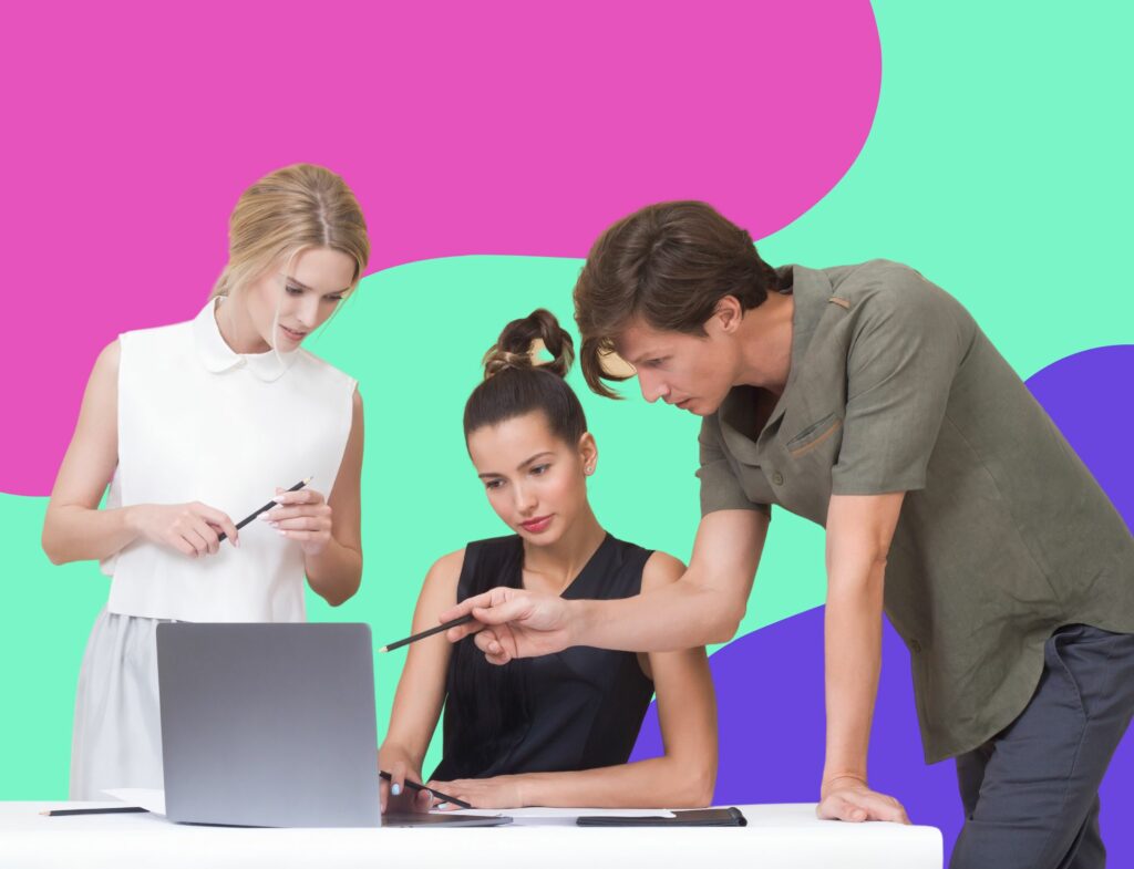 Two business woman and man collaborating at a laptop in a post about AI blog writing for beauty brands, published by Lyon Content