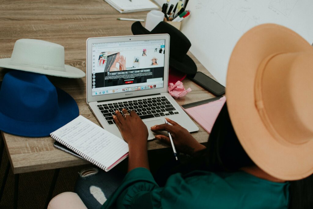 woman writing on laptop and notebook in post about AI blog writing