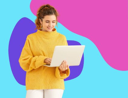 woman in yellow sweater holding laptop in front of colorful background with abstract shapes reading about an on-page SEO checklist