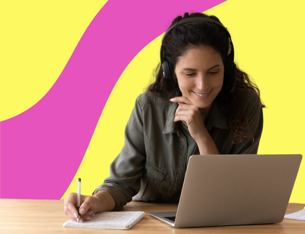 woman in headphones smiles while working on laptop for article about on-page SEO checklist