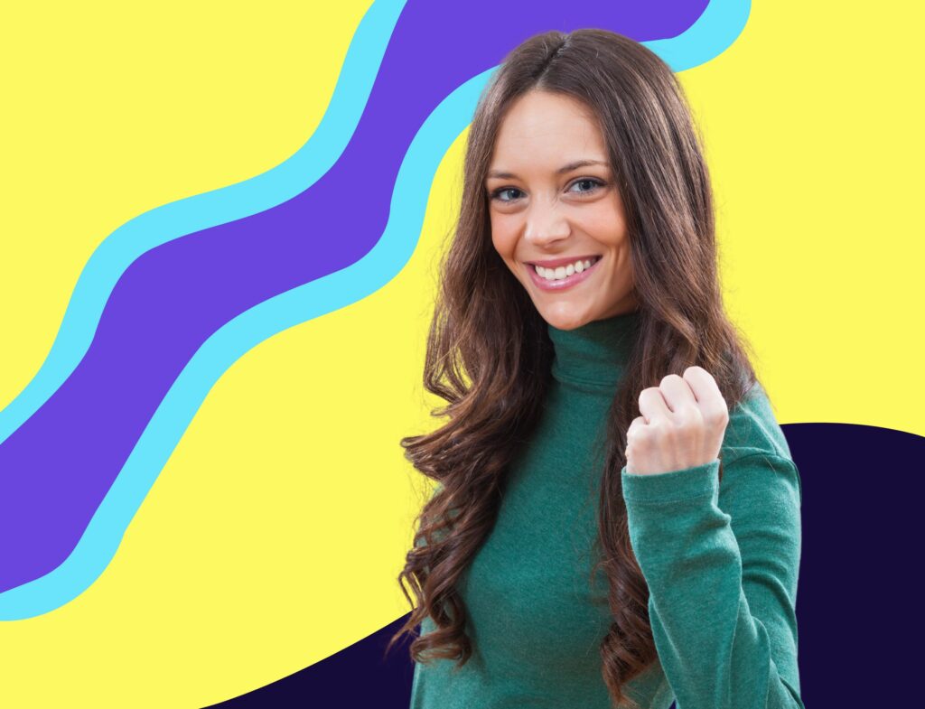 woman smiling with fist up in success with colorful background