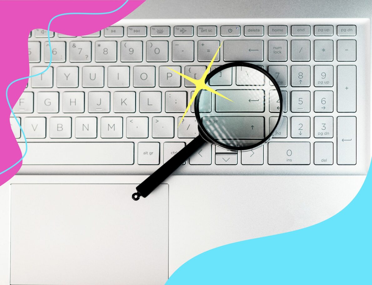 magnifying glass on computer keyboard with wavy borders for lyon content post about keyword difficulty
