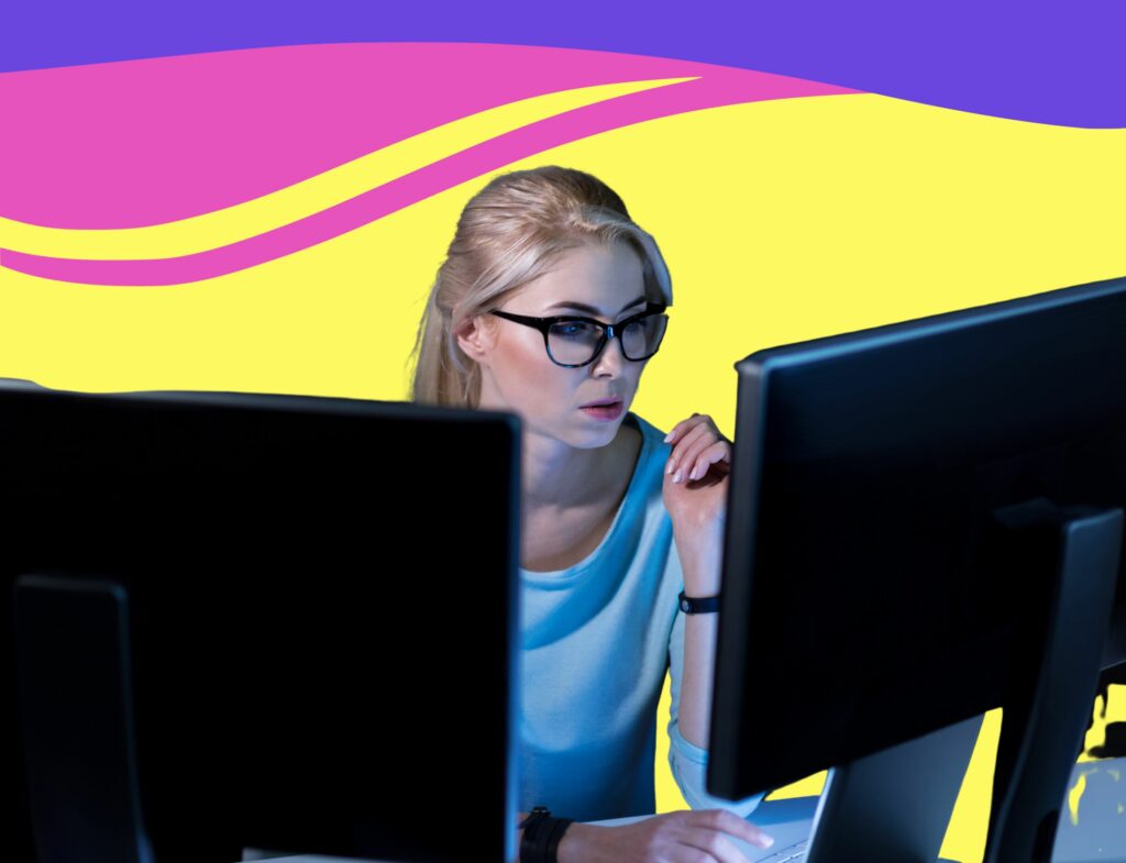 woman with glasses looking intently at two computer monitors in front of swirling background