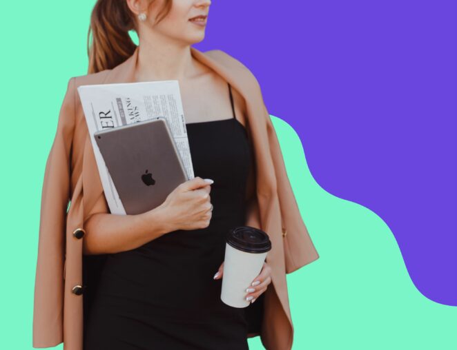 professional woman holding laptop and newspaper for article about how to write a press release
