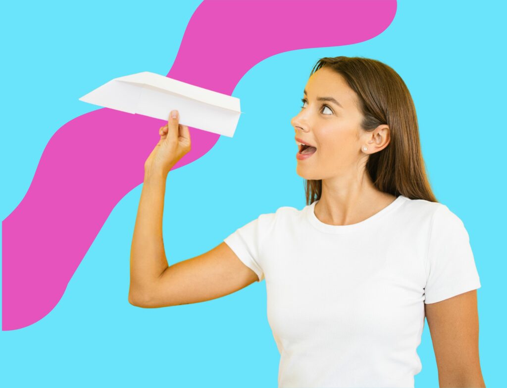 colorful image of woman sending paper airplane for Lyon Content post about how to write a press release