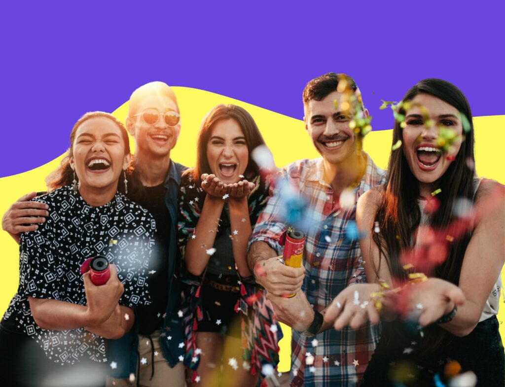 group of friends celebrating at event with confetti in front of bright wavy background