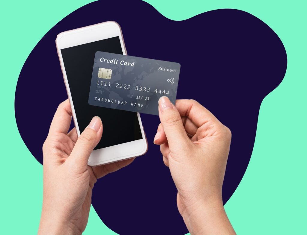 hands holding iPhone and credit card in front of abstract background to highlight transactional search intent