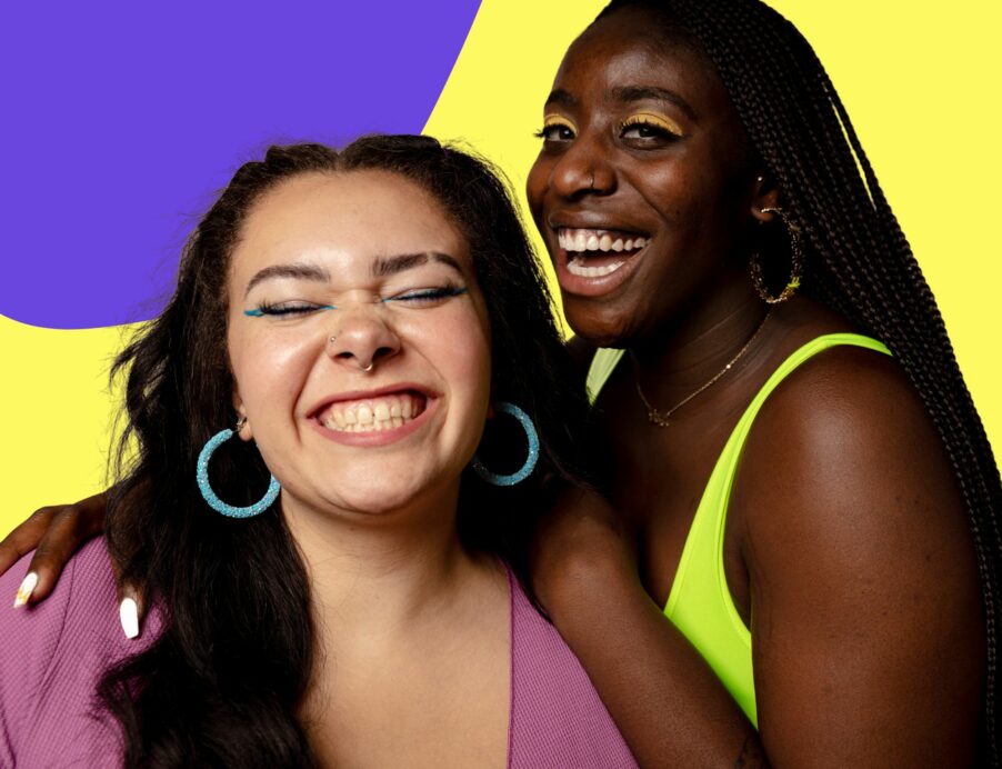 Two women of color smiling in front of yellow and blue background for diversity in beauty market article